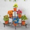 Stainless steel plant stand with three flower pots for home and garden decor.